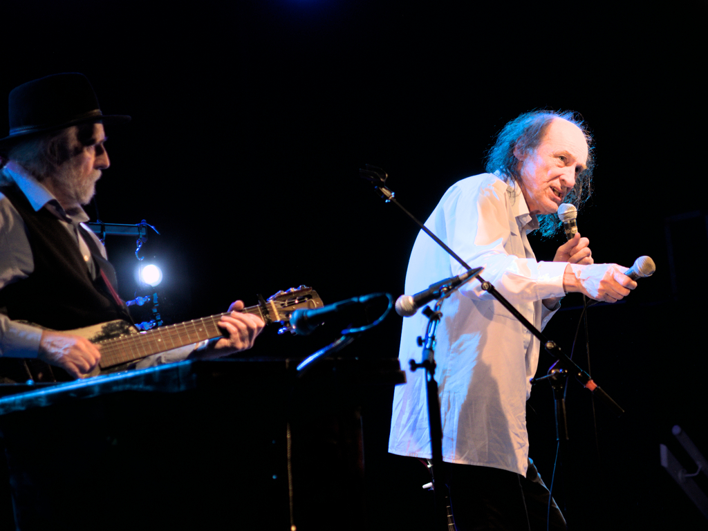 John Otway singing with two mics while Wild Willy Barrett is playing in the background.