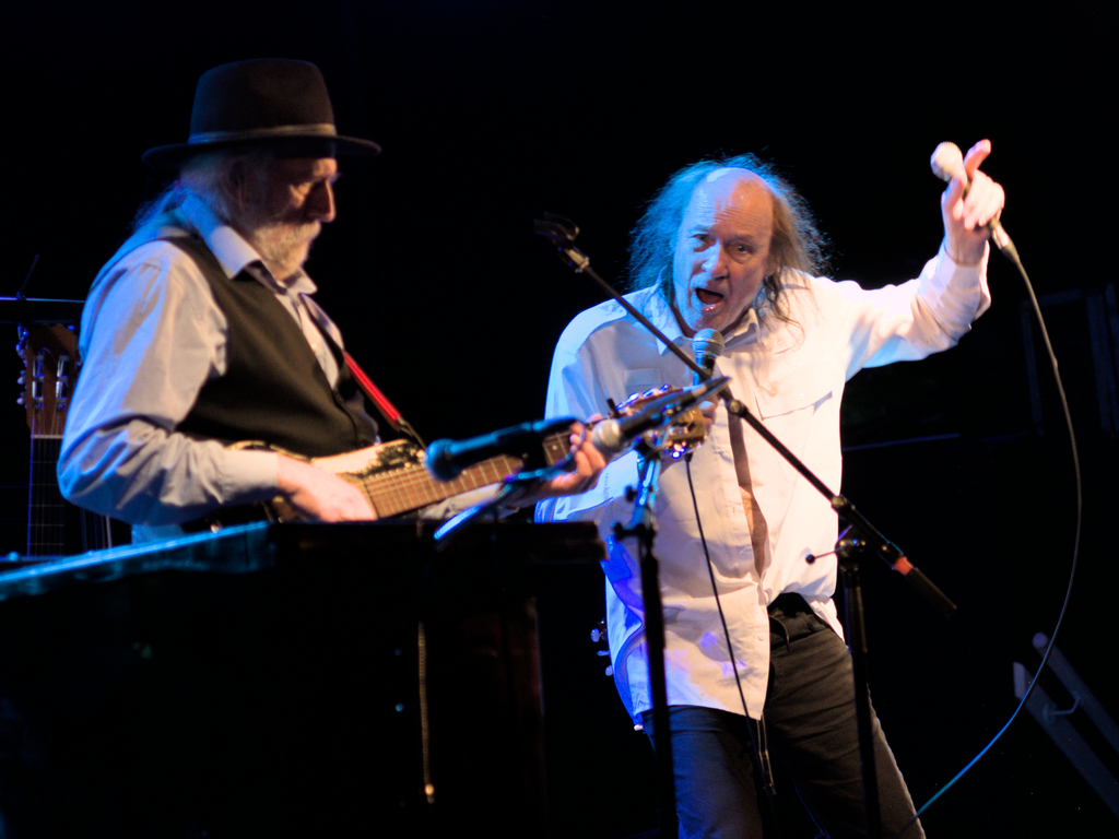 John Otway singing with two mics while Wild Willy Barrett is playing in the background.