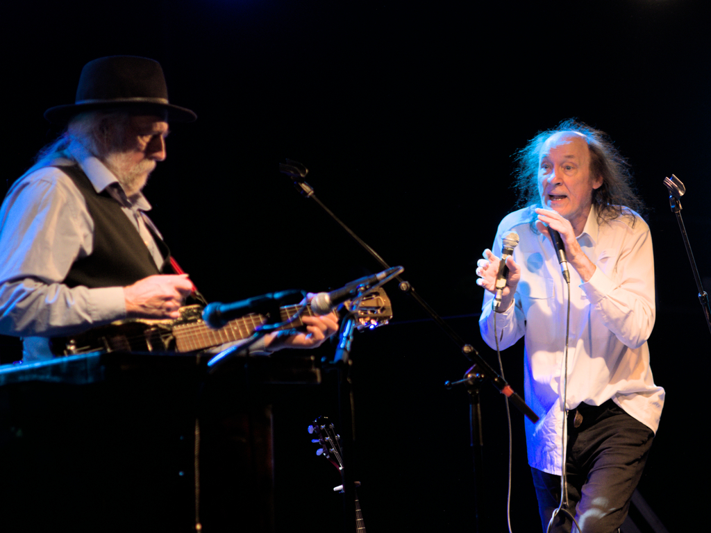 John Otway singing with two mics while Wild Willy Barrett is playing in the background.